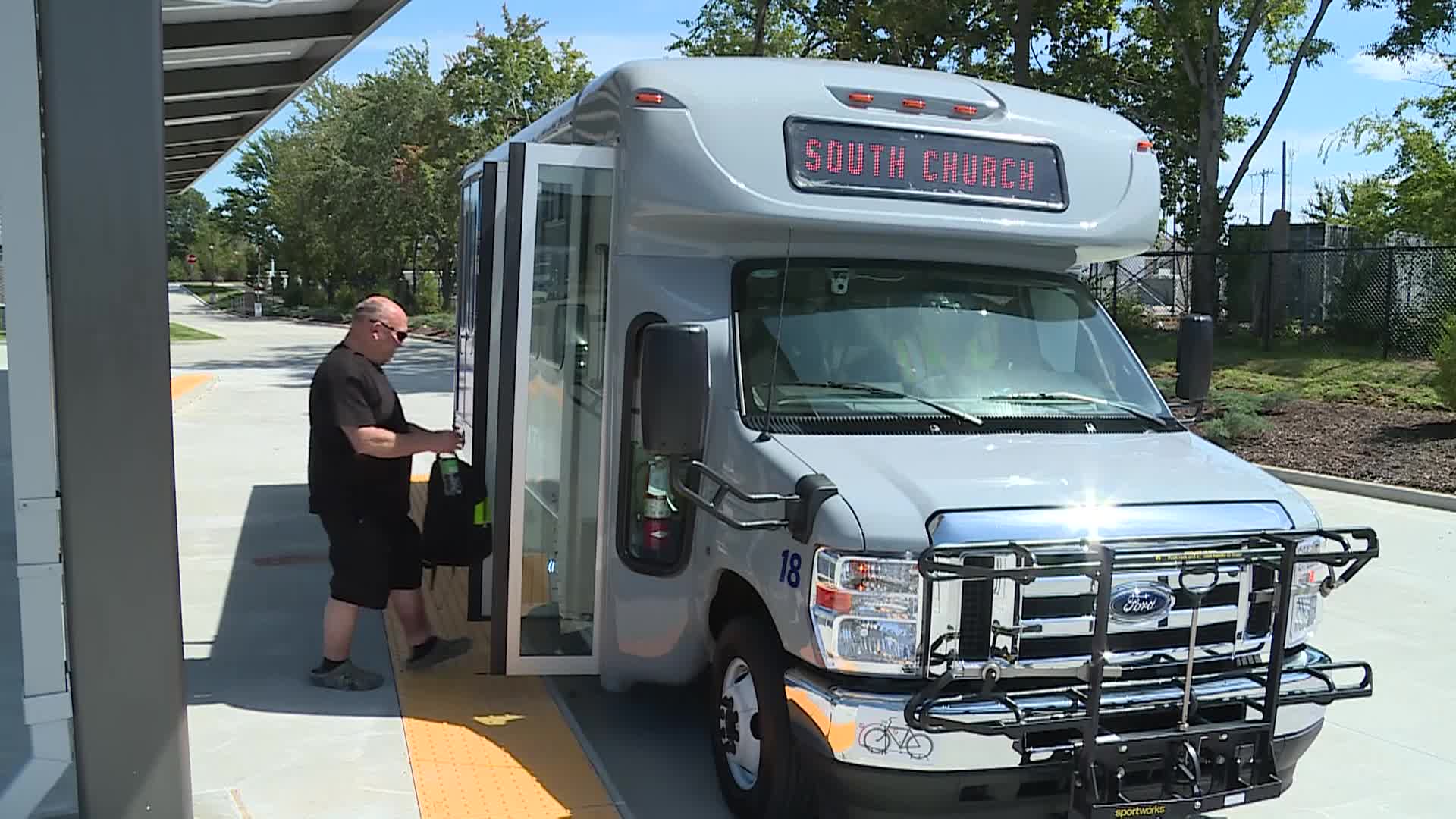 man entering door of bus at new transit center