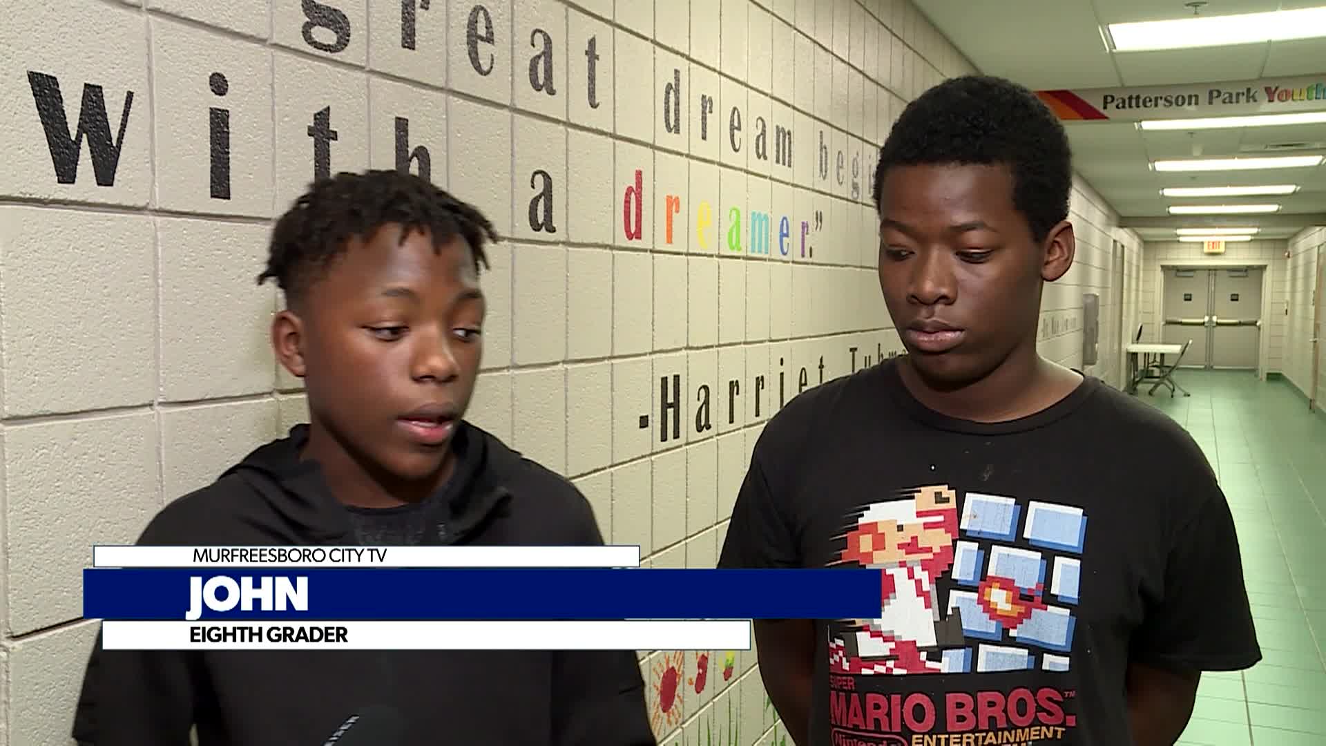 two artist and students get interviewed about murals