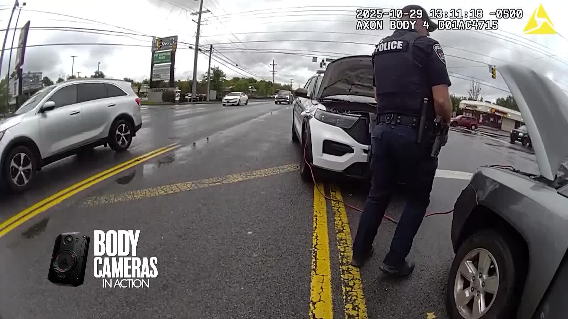Police officers with jumper cables trying to get a motorist's car started